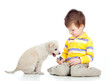 Photo: cute child playing with a puppy cute child playing with a puppy