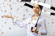 Foto: Business woman under money rain with umbrella Business woman under money rain with umbrella