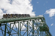 cars with people hung in a track of a roller coaster