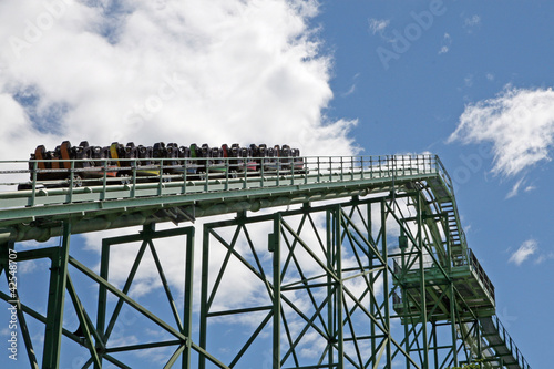 Photo: cars with people hung in a track of a roller coaster cars with people hung in a track of a roller coaster