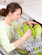Dishwasher. Young woman in the Kitchen doing Housework. Wash-up