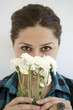 girl smelling white flowers