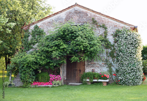 Photo: old rural house with garden flowers and Jasmine old rural house with garden flowers and Jasmine