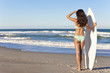 Beautiful Woman Surfer In Bikini With Surfboard At Beach