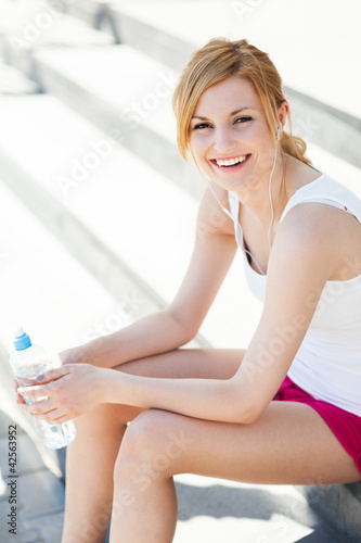 Photo: Young woman with bottle of water Young woman with bottle of water