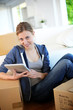 Young girl websurfing on tablet in new flat