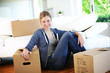 Young girl sitting by cardboards in new home