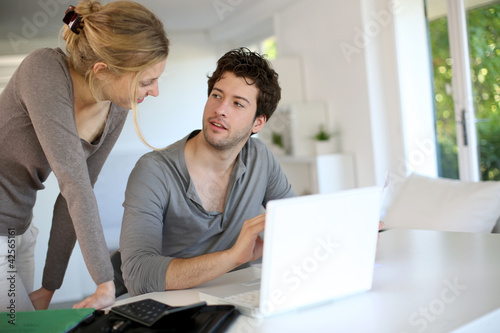 Photo: Young people studying from home with laptop computer Young people studying from home with laptop computer