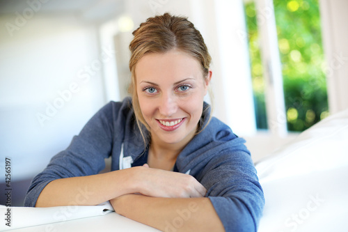 Photo: Beautiful blond girl relaxing at home Beautiful blond girl relaxing at home