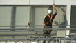 Video: Construction worker on scaffolding repairing the building Construction worker on scaffolding repairing the building