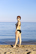 harmonous woman wearing spectacles sunbathes about the sea