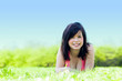Young happy girl lying on grass