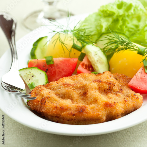 Photo: Wiener Schnitzel with potatoes and fresh vegetables Wiener Schnitzel with potatoes and fresh vegetables