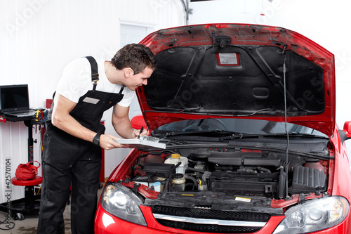 Photo: Professional auto mechanic. Professional auto mechanic.