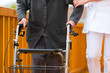 Alter und Pflege - Pflegerin und eine Seniorin mit Rollator