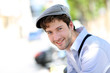 Portrait of young trendy guy standing outside