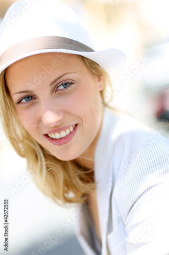 Photo: Closeup of beautiful young woman with hat Closeup of beautiful young woman with hat