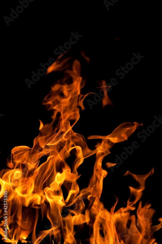 Photo: isolated on black yellow flame isolated on black yellow flame
