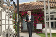 Photo: Portrait of a senior real estate agent walking with clipboard Portrait of a senior real estate agent walking with clipboard