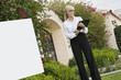 Photo: Senior female agent reading from clipboard Senior female agent reading from clipboard
