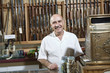 Portrait of a mature merchant in gun shop