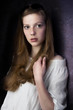 red head on violet wall
