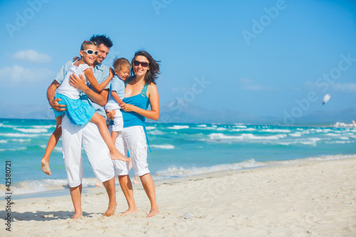 Photo: Family having fun on tropical beach Family having fun on tropical beach