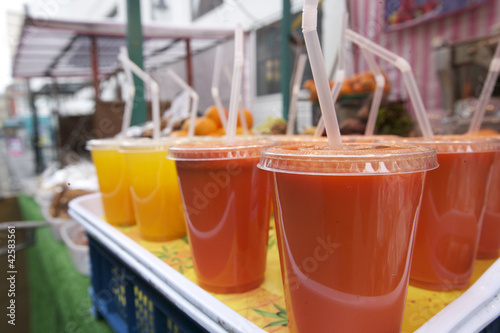 Photo: Close-up of fruit juices on display at market stall Close-up of fruit juices on display at market stall