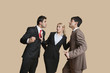 Photo: Furious businessmen in conflict with woman trying to resolve over colored background Furious businessmen in conflict with woman trying to resolve over colored background
