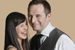 Portrait of cheerful young couple over colored background