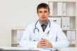 Young male doctor in white uniform