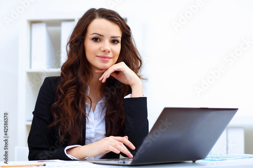Photo: Young busines woman with notebook Young busines woman with notebook