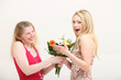 Woman exclaiming over a gift of flowers