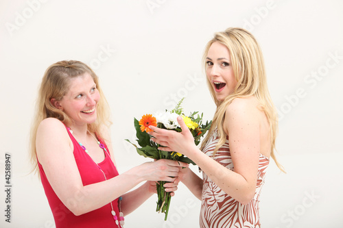 Photo: Woman exclaiming over a gift of flowers Woman exclaiming over a gift of flowers