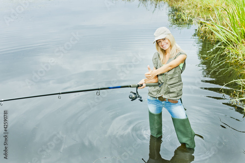 Photo: woman fishing in pond woman fishing in pond