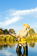woman fishing in pond