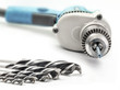 Drill and drill bits, selective focus, on white background