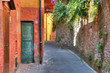 Narrow street among house and wall in Portofino.