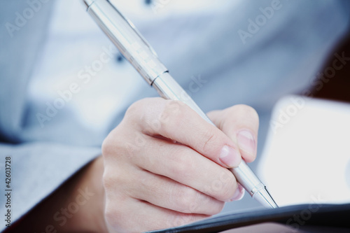 Photo: woman write by pen woman write by pen
