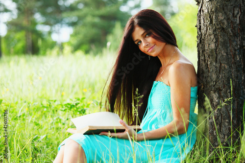 Photo: Beautiful Healthy Woman over Nature background Beautiful Healthy Woman over Nature background