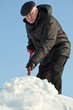 Photo: Man shovelling snow from a road Man shovelling snow from a road