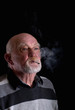 Photo: Senior person smoking a cigarette Senior person smoking a cigarette