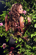 woman standing among the rose bushes