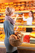 Photo : Salesperson with female customer in bakery Salesperson with female customer in bakery