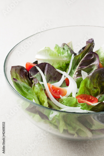 Photo: salad with lettuce, tomato and onion salad with lettuce, tomato and onion