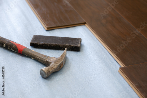 Photo: Hammer and Block with New Laminate Flooring Hammer and Block with New Laminate Flooring