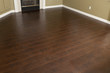 Photo: Newly Installed Brown Laminate Flooring and Baseboards in Home Newly Installed Brown Laminate Flooring and Baseboards in Home