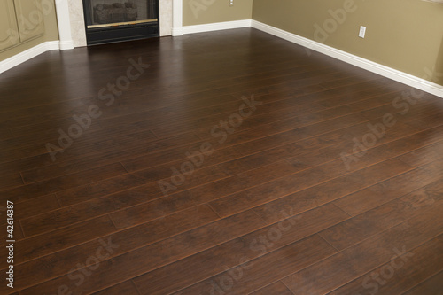 Photo: Newly Installed Brown Laminate Flooring and Baseboards in Home Newly Installed Brown Laminate Flooring and Baseboards in Home
