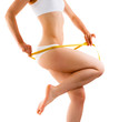 Photo: Woman measuring her slim body isolated on white Woman measuring her slim body isolated on white