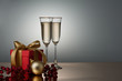 Photo: Two champagne glasses on a golden surface Two champagne glasses on a golden surface